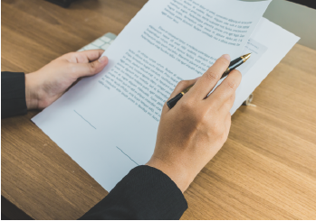 A person reviewing the terms and conditions within a contract