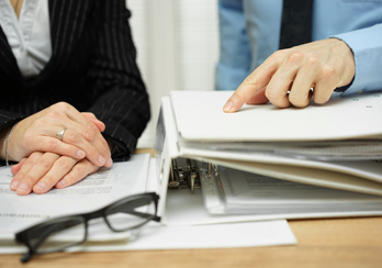Two people speaking with each other during a meeting