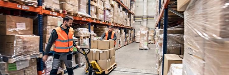 A shipping professional moving packaged products