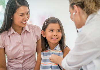 Child smiling at doctor during a check up