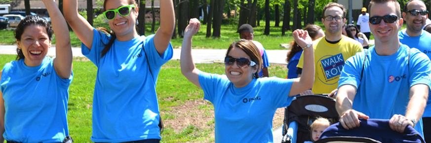 PSEG Employees walking with hands up in celebration at park