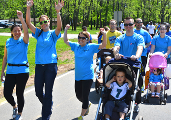 PSEG employees walking together with hands in the air