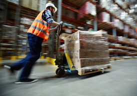 A person pushing a hand truck