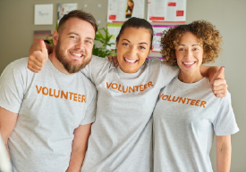 Three volunteers with their arms around each other