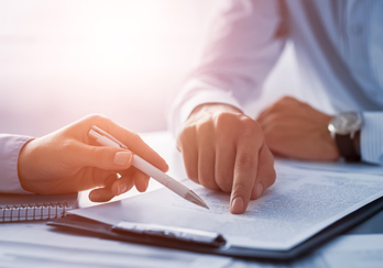 Two people discussing financial disclosures