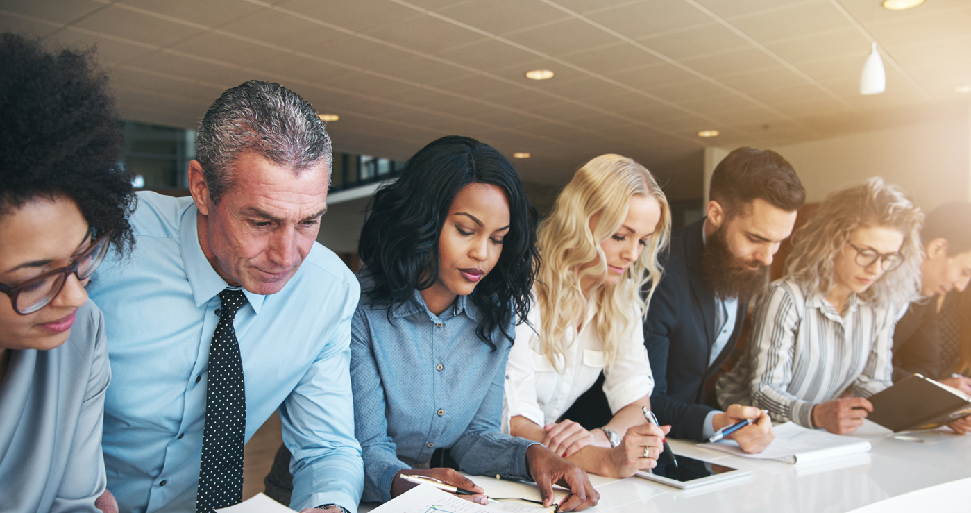 A diverse group of colleagues reviewing documentation