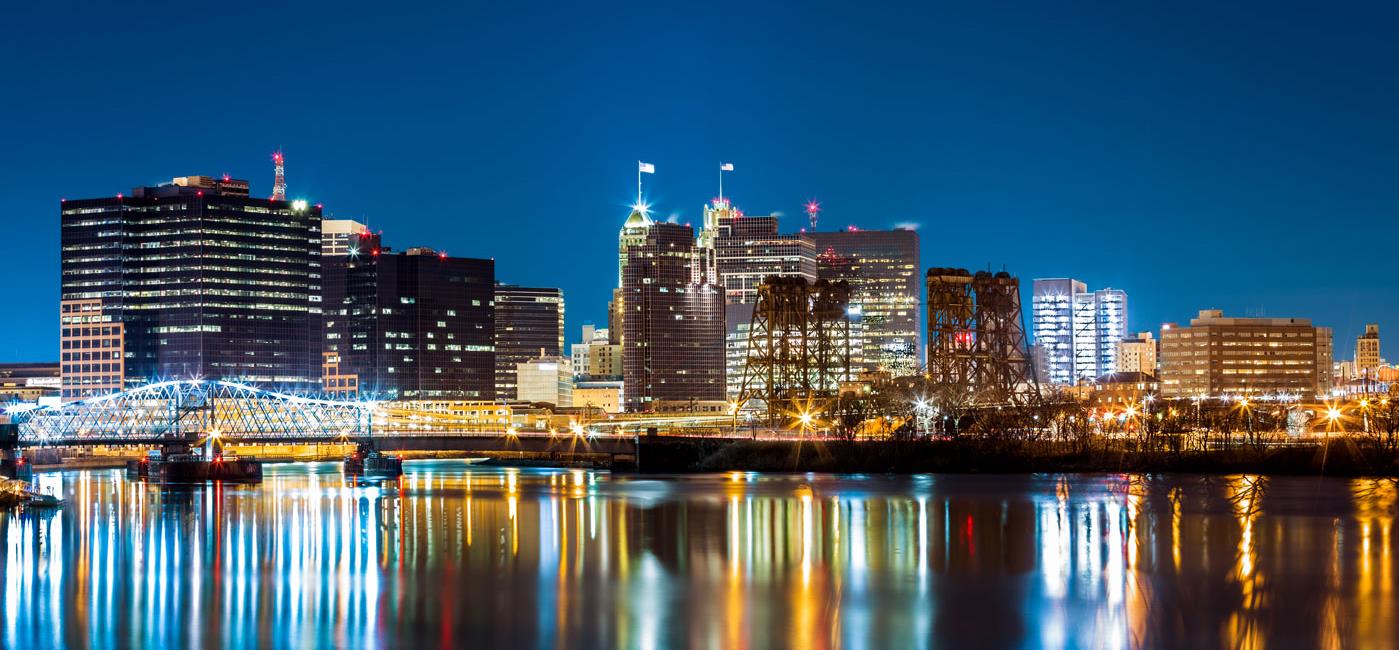 Newark, New Jersey skyline at night is shown.