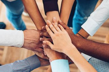 A diverse number of hands are shown together.