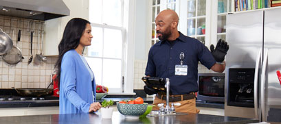 A PSE&G energy efficiency consultant is shown talking with a customer.