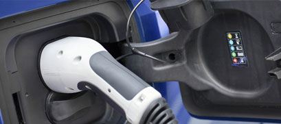 EV Charger is shown plugged into an electric vehicle.