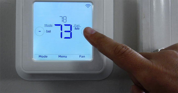 Thermostat is shown being temperature adjusted.